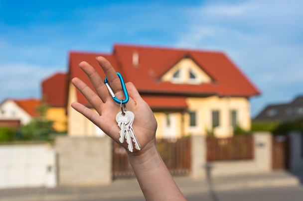 Makelaar huis sleutels te geven aan een nieuwe eigenaar - Foto, afbeelding