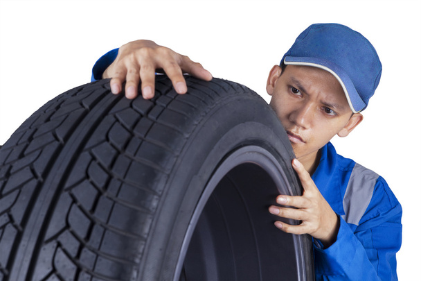 Technician examining a tire - Фото, зображення