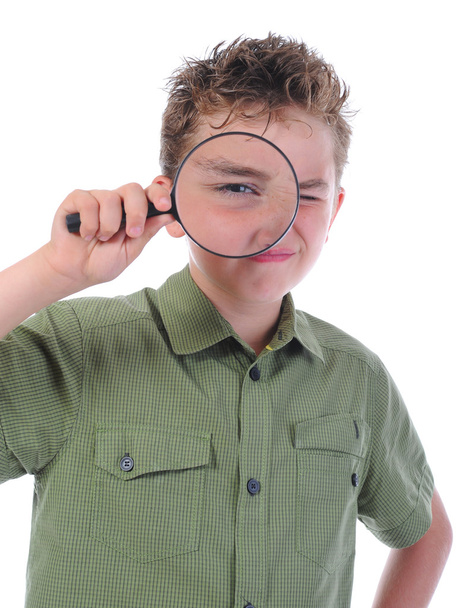 Boy looking through a magnifying glass - Fotó, kép