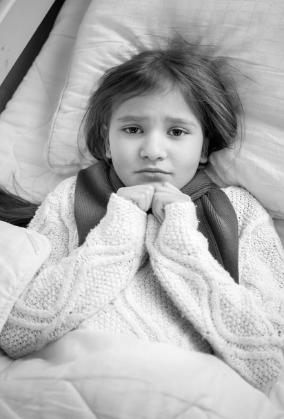 Black and white portrait of girl with flu lying in bed - Fotografie, Obrázek
