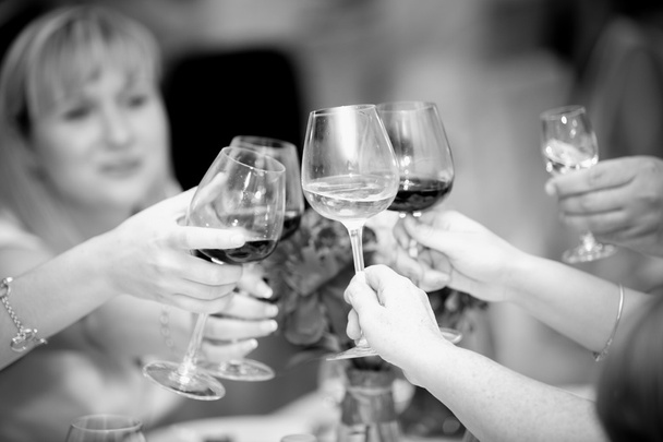 black and white photo of clinking glasses with wine at restauran - Photo, Image