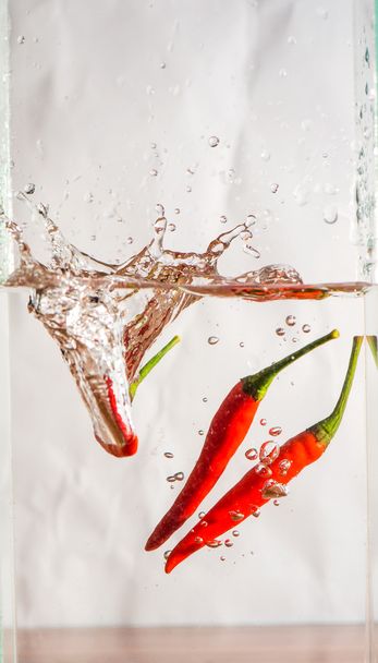 effect when drop chili into the water - Foto, Bild