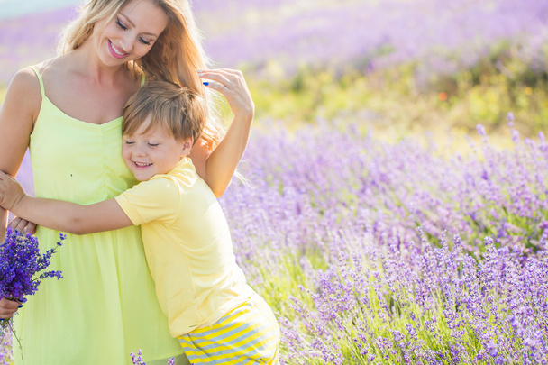 Mother with little son on lavender field - Φωτογραφία, εικόνα