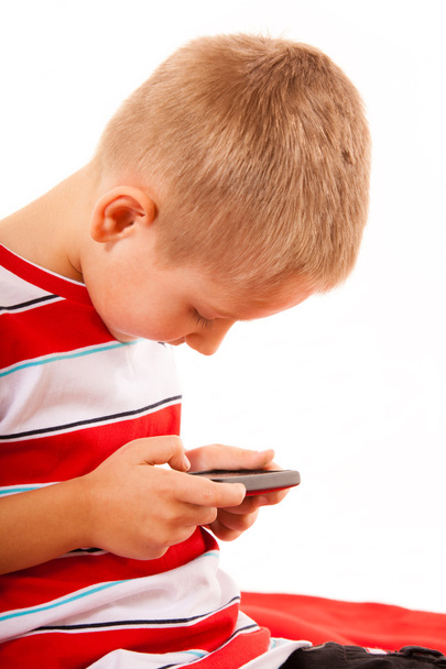 Little boy playing games on smartphone - Фото, изображение