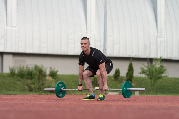Young Man Doing A Deadlift Exercise Outdoor - Foto, afbeelding