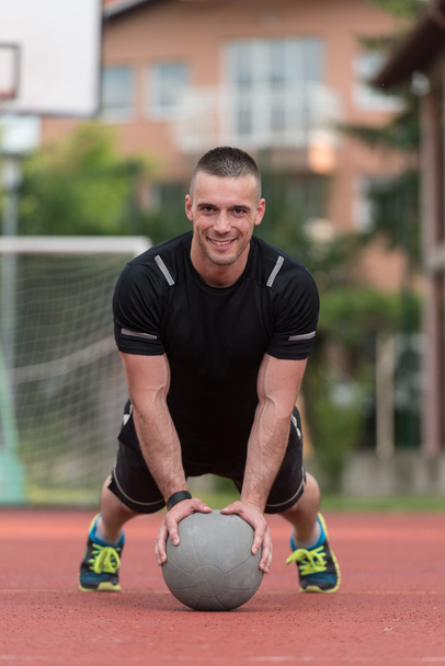 Young Man Exercising Push-Ups On Medicine Ball Outdoor - Foto, immagini