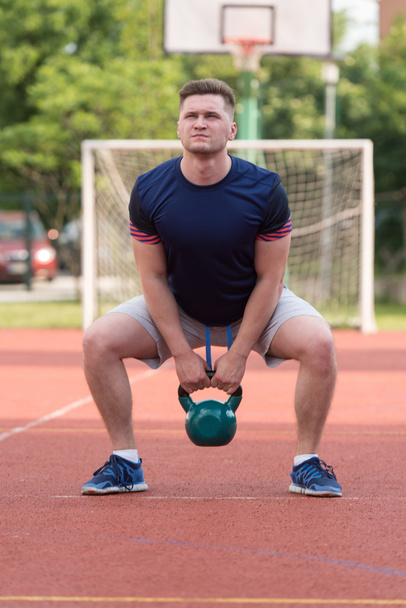 Young Man Working Out With A Kettle Bell - Zdjęcie, obraz
