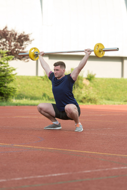 Young Man Doing A Overhead Squat Exercise Outdoor - Foto, Imagen