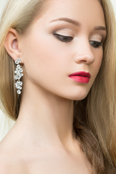 beautiful girl with red lips and earrings. fashion photo - Фото, изображение