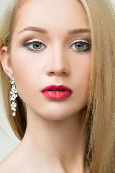 beautiful girl with red lips and earrings. fashion photo - Fotó, kép