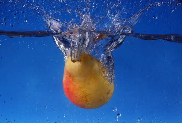splash with pear on a blue background - Foto, afbeelding