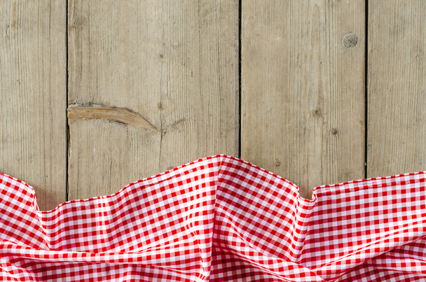 Red folded tablecloth over wooden table - Foto, Imagen