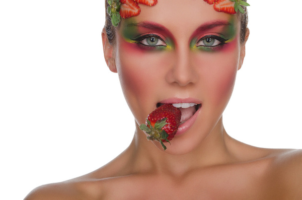 young woman with strawberries on face and teeth - Fotografie, Obrázek