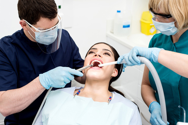 Dentist examining a woman teeth - Photo, image