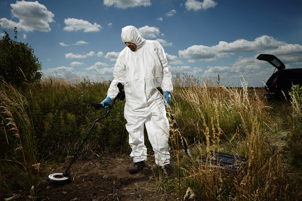 Criminologist technician exploring place with metal detector - Fotografie, Obrázek