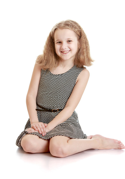 Charming teenage girl sat on the floor with bare feet - Фото, зображення