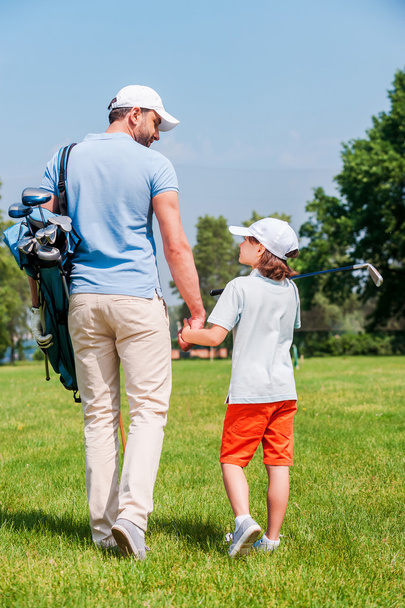 man and his son walking on  golf course - Foto, Imagen