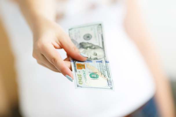 Hand of woman giving money - Foto, imagen