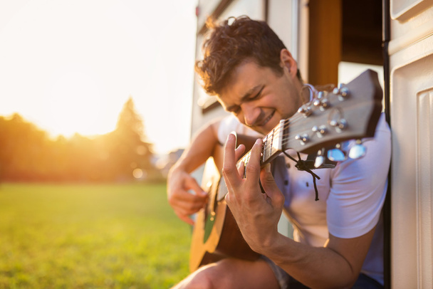 Handsome man playing guitar - Foto, afbeelding