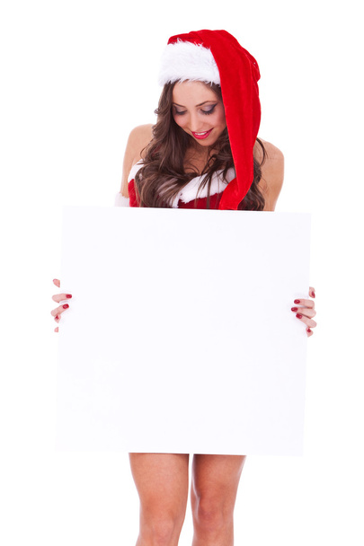 Santa woman looking at a blank board - Фото, изображение