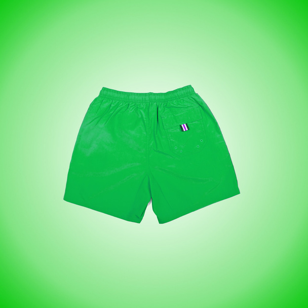 Male shorts the green background - Photo, Image