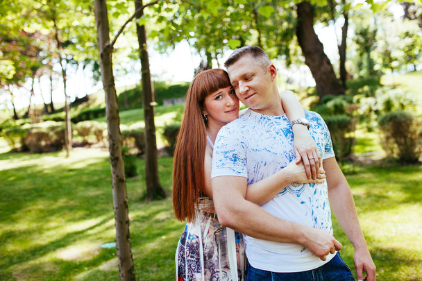 Pregnant couple in the park - 写真・画像