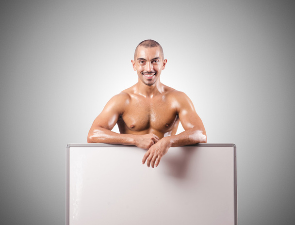 Medio hombre desnudo con tablero en blanco
 - Foto, Imagen