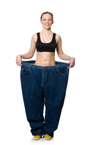 Dieting concept with big jeans on white - Photo, Image