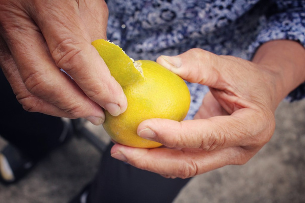 Vanhempi nainen syö appelsiinihedelmiä
 - Valokuva, kuva
