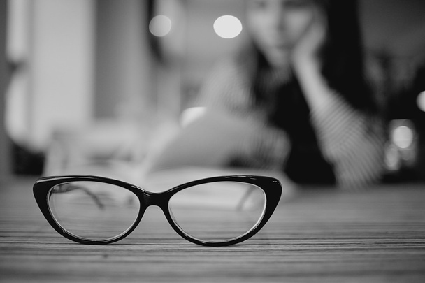 Eye glasses on wooden table - Valokuva, kuva