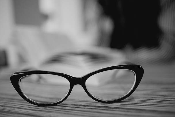 Eye glasses on wooden table - Фото, зображення