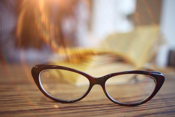 Eye glasses on wooden table - Foto, imagen
