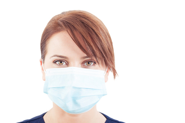 Beautiful face of a woman doctor wearing surgical mask - Foto, afbeelding