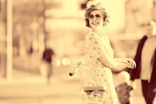 girl  with a bicycle on the street - Foto, Imagem