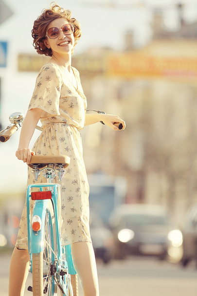 girl  with a bicycle on the street - Φωτογραφία, εικόνα