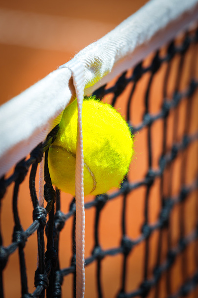Tennis ball in net - Фото, изображение