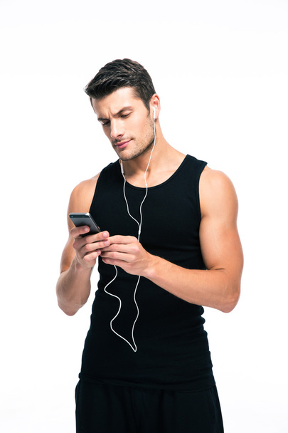 Fitness man using smartphone with headphones - Fotó, kép