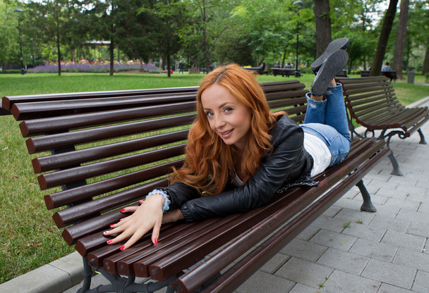 Beautiful blond woman sitting on bench - Φωτογραφία, εικόνα
