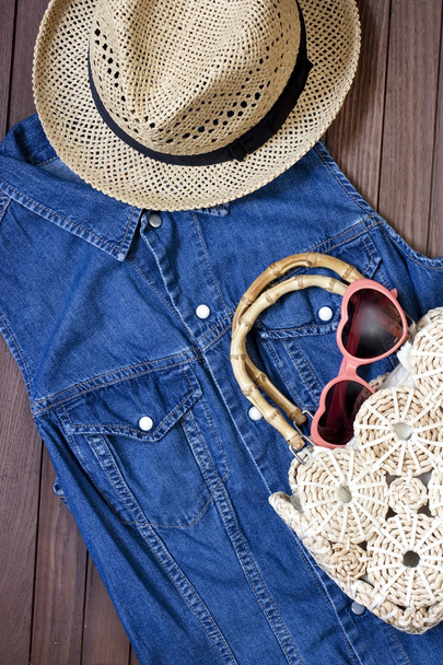 Sunglasses and wicker hat on table - 写真・画像