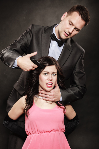 Scene of violence with firearm between men and women. - Foto, Bild