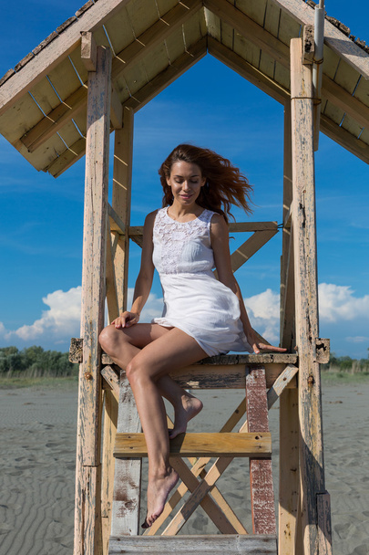 young attractive girl posing on a lifeguard tower  - 写真・画像