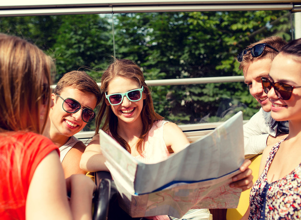 group of smiling friends traveling by tour bus - Photo, image