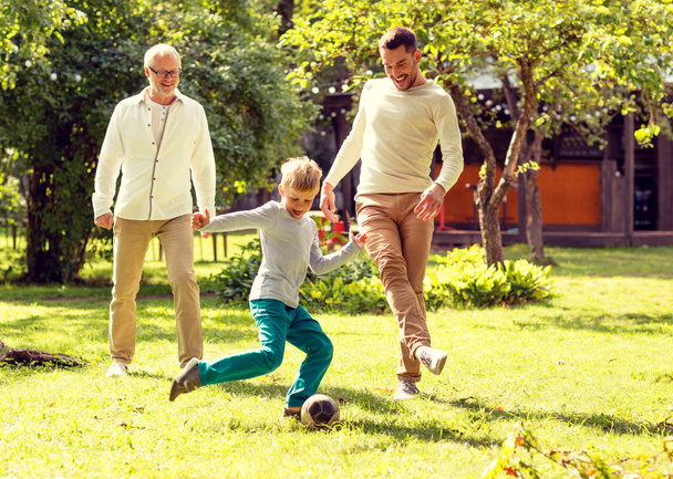 happy family playing football outdoors - Foto, immagini