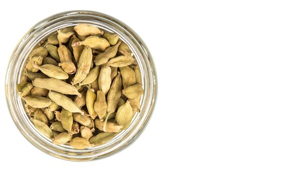 Cardamom spices in a mason jar over white background - Photo, Image