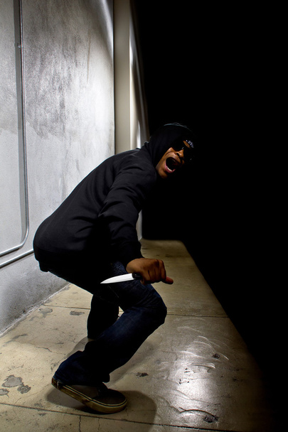 criminal with a knife hiding - Фото, изображение