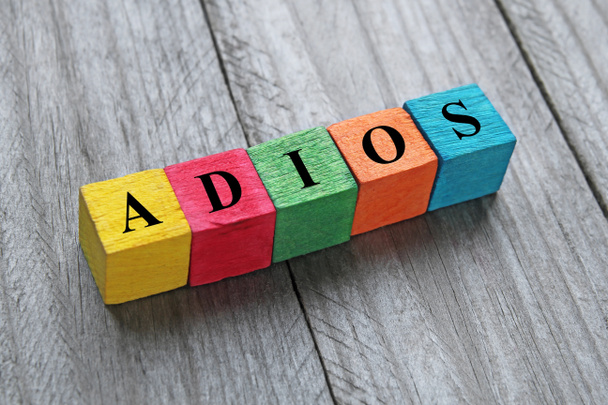 word adios (good bye in spanish) on colorful wooden cubes - Fotoğraf, Görsel