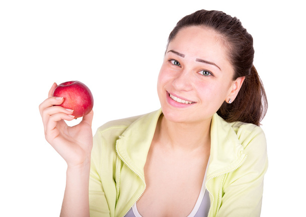 girl holding an apple in her hand and smiling - 写真・画像