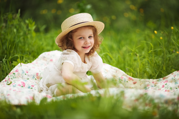 Little happy girl is sitting and resting - Fotografie, Obrázek