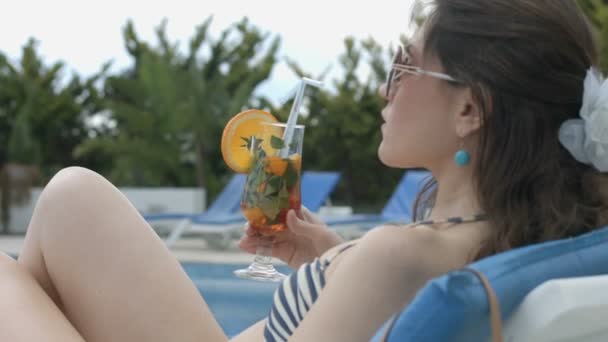 Sexy woman drinking fresh cocktail near swimming pool, vacation - Metraje, vídeo