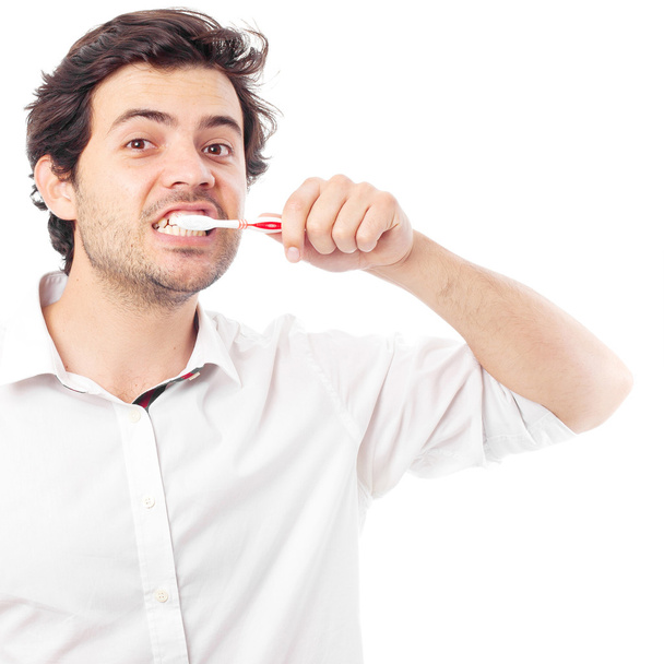 young man brushing teeth - Фото, изображение